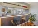 Charming kitchen bar featuring custom lighting and an open view to the main kitchen at 726 Bird Bay W Dr # 153, Venice, FL 34285