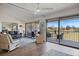 Comfortable living room with golf course views and access to the screened lanai via sliding glass doors at 726 Bird Bay W Dr # 153, Venice, FL 34285