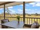 Relaxing screened patio with table and seating overlooking manicured green space at 726 Bird Bay W Dr # 153, Venice, FL 34285
