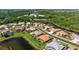 A high-angle view showcases the home's location near the lake and neighborhood at 744 Fringed Orchid Trl, Venice, FL 34293
