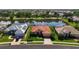 Aerial view of a charming neighborhood with lake, landscaped yards, and tile roofs at 744 Fringed Orchid Trl, Venice, FL 34293