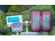 Aerial view of a community pool and tennis courts adjacent to a scenic pond at 744 Fringed Orchid Trl, Venice, FL 34293
