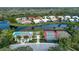 Aerial shot of community pool, tennis courts, and scenic waterfront homes at 744 Fringed Orchid Trl, Venice, FL 34293