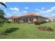 Well maintained backyard features plush green grass and a screened-in lanai at 744 Fringed Orchid Trl, Venice, FL 34293