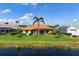 Well maintained backyard with plush green grass and a view of the pond at 744 Fringed Orchid Trl, Venice, FL 34293