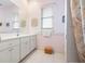 Bathroom with light pink walls, a white vanity, and tiled floors at 744 Fringed Orchid Trl, Venice, FL 34293
