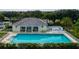 Community pool with ample seating, a covered patio, and mature landscaping at 744 Fringed Orchid Trl, Venice, FL 34293