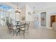 Spacious dining area with high ceilings, large window, and stylish lighting fixtures at 744 Fringed Orchid Trl, Venice, FL 34293