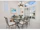 Elegant dining area with large windows, letting in plenty of light and enhancing the eating space at 744 Fringed Orchid Trl, Venice, FL 34293