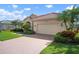 The property has a paver driveway, tile roof, and 2 car garage at 744 Fringed Orchid Trl, Venice, FL 34293