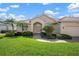 Charming single-story home featuring a red tile roof, paver driveway, and lush green landscaping at 744 Fringed Orchid Trl, Venice, FL 34293