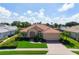 Charming single-story home features a tile roof, two-car garage, and well-manicured lawn at 744 Fringed Orchid Trl, Venice, FL 34293