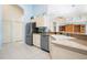 Functional kitchen with a modern dishwasher, white cabinetry and ample counter space at 744 Fringed Orchid Trl, Venice, FL 34293