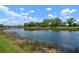 The property has a tranquil lake view surrounded by lush landscaping at 744 Fringed Orchid Trl, Venice, FL 34293