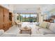 Open living room boasts sliding doors to screened patio and backyard water views at 744 Fringed Orchid Trl, Venice, FL 34293