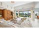 Bright living room with high ceilings and sliding doors to screened patio overlooking lush backyard and water at 744 Fringed Orchid Trl, Venice, FL 34293