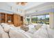 Bright living room with high ceilings and sliding doors to screened patio overlooking lush backyard and water at 744 Fringed Orchid Trl, Venice, FL 34293