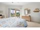 Comfortable main bedroom featuring water views and outdoor access at 744 Fringed Orchid Trl, Venice, FL 34293