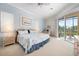 Light and airy main bedroom with lanai access and an ensuite bathroom at 744 Fringed Orchid Trl, Venice, FL 34293