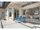 Covered patio with blue table and chairs leading to the house and open floor plan at 744 Fringed Orchid Trl, Venice, FL 34293