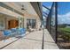 Covered patio with tiled floor features a ceiling fan and view of the backyard at 744 Fringed Orchid Trl, Venice, FL 34293