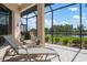 Covered patio area with lounge seating and views of the water and landscaping at 744 Fringed Orchid Trl, Venice, FL 34293