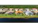 Back of home view displaying a screened-in lanai overlooking a serene lake at 744 Fringed Orchid Trl, Venice, FL 34293