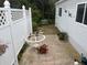 Cozy backyard patio area with white lattice fencing, perfect for outdoor relaxation at 795 Cervina N Dr, Venice, FL 34285