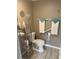 Well-organized bathroom with a toilet, shelving, and towel rack for convenience at 795 Cervina N Dr, Venice, FL 34285