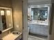 An ensuite bathroom with double sinks, vanity, mirror, and ample storage at 795 Cervina N Dr, Venice, FL 34285