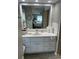 Bathroom featuring a well-lit vanity with double sinks, a mirror, and a shower at 795 Cervina N Dr, Venice, FL 34285