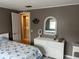 Bedroom with view of dresser and doorway to bathroom at 795 Cervina N Dr, Venice, FL 34285