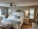 Comfortable bedroom featuring a king bed, ceiling fan, and light-filled windows at 795 Cervina N Dr, Venice, FL 34285