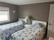 Bright bedroom with two twin beds and a calming color palette at 795 Cervina N Dr, Venice, FL 34285