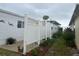 Exterior side view with garden and plants near a patio area with privacy fence at 795 Cervina N Dr, Venice, FL 34285