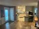 Open-concept kitchen with white cabinets and a breakfast bar, seamlessly flowing into the living area at 795 Cervina N Dr, Venice, FL 34285