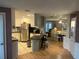 Open kitchen with white cabinets, stainless steel appliances, and a breakfast bar overlooking the dining area at 795 Cervina N Dr, Venice, FL 34285