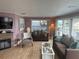Cozy living room featuring a decorative fireplace, plush seating, and ample natural light at 795 Cervina N Dr, Venice, FL 34285