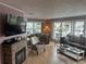 Bright living room with hardwood floors, stone fireplace and large windows at 795 Cervina N Dr, Venice, FL 34285