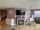 Inviting corner living area featuring fireplace with large screen tv and modern decor at 795 Cervina N Dr, Venice, FL 34285