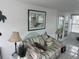 Comfortable living room with neutral decor and sliding glass doors to the sunroom at 795 Cervina N Dr, Venice, FL 34285