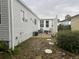 Outdoor patio space with stepping stones, a white picket fence, and tropical plants at 795 Cervina N Dr, Venice, FL 34285