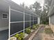 Enclosed back porch with screens providing a cozy and private outdoor living space at 795 Cervina N Dr, Venice, FL 34285