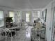Relaxing sun room with white furniture and views of the backyard at 795 Cervina N Dr, Venice, FL 34285