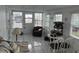 Bright sunroom with white tile floor and multiple windows for abundant natural light at 795 Cervina N Dr, Venice, FL 34285