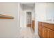Bathroom with vanity, mirror, tile floors, and a hallway leading to a closet at 799 Harrington Lake N Dr # 73, Venice, FL 34293