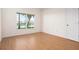 Bedroom featuring wood floors and scenic lake views from a large window at 799 Harrington Lake N Dr # 73, Venice, FL 34293