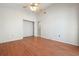 This bedroom boasts wood floors, a ceiling fan, an closet and entrance to another room at 799 Harrington Lake N Dr # 73, Venice, FL 34293