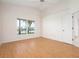 Bedroom with wood floors and a window overlooking a picturesque lake at 799 Harrington Lake N Dr # 73, Venice, FL 34293