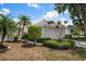 Charming single-story home with manicured landscaping, palm trees and an attached two-car garage at 799 Harrington Lake N Dr # 73, Venice, FL 34293